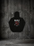 Hoodie B.R.I SURVIVORRR, vue dos sur mur béton